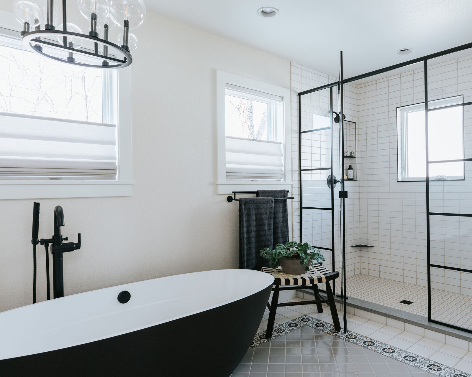 Primary bath with black freestanding tub and black-framed glass shower, Fort Collins