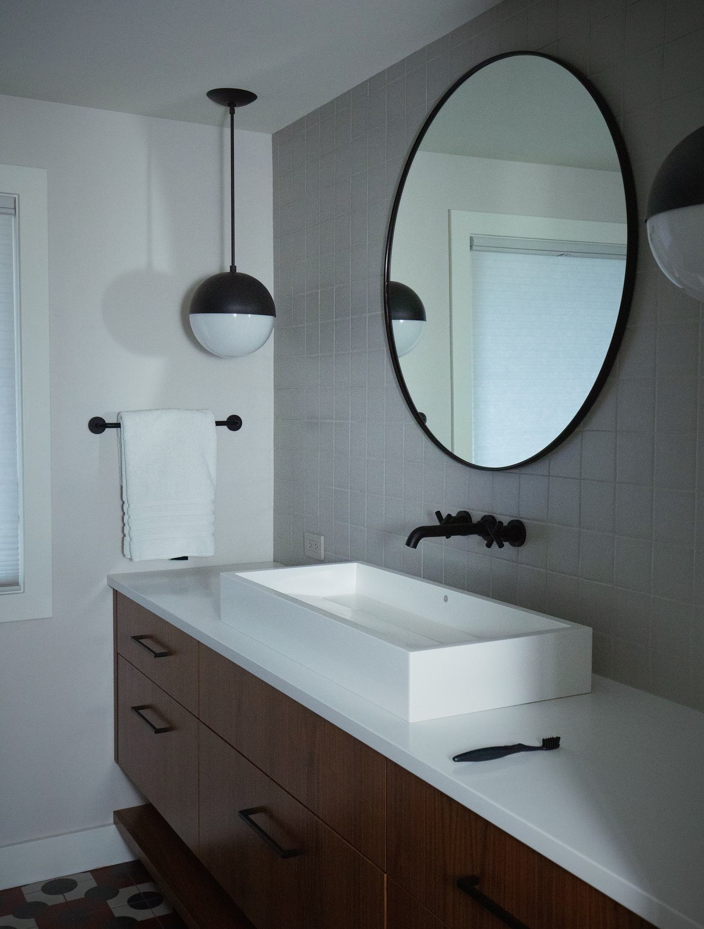 Custom walnut vanity with round mirror